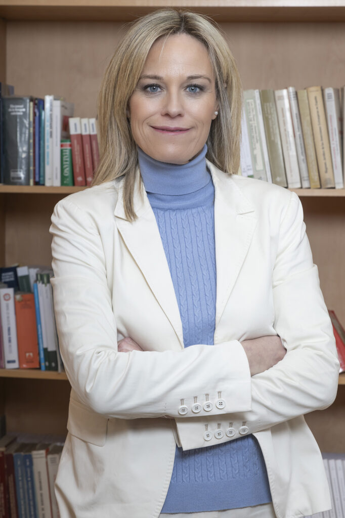 Retrato profesional de mujer con blazer en oficina con estantería en Barcelona – fotografía de marca personal por La Fotógrafa